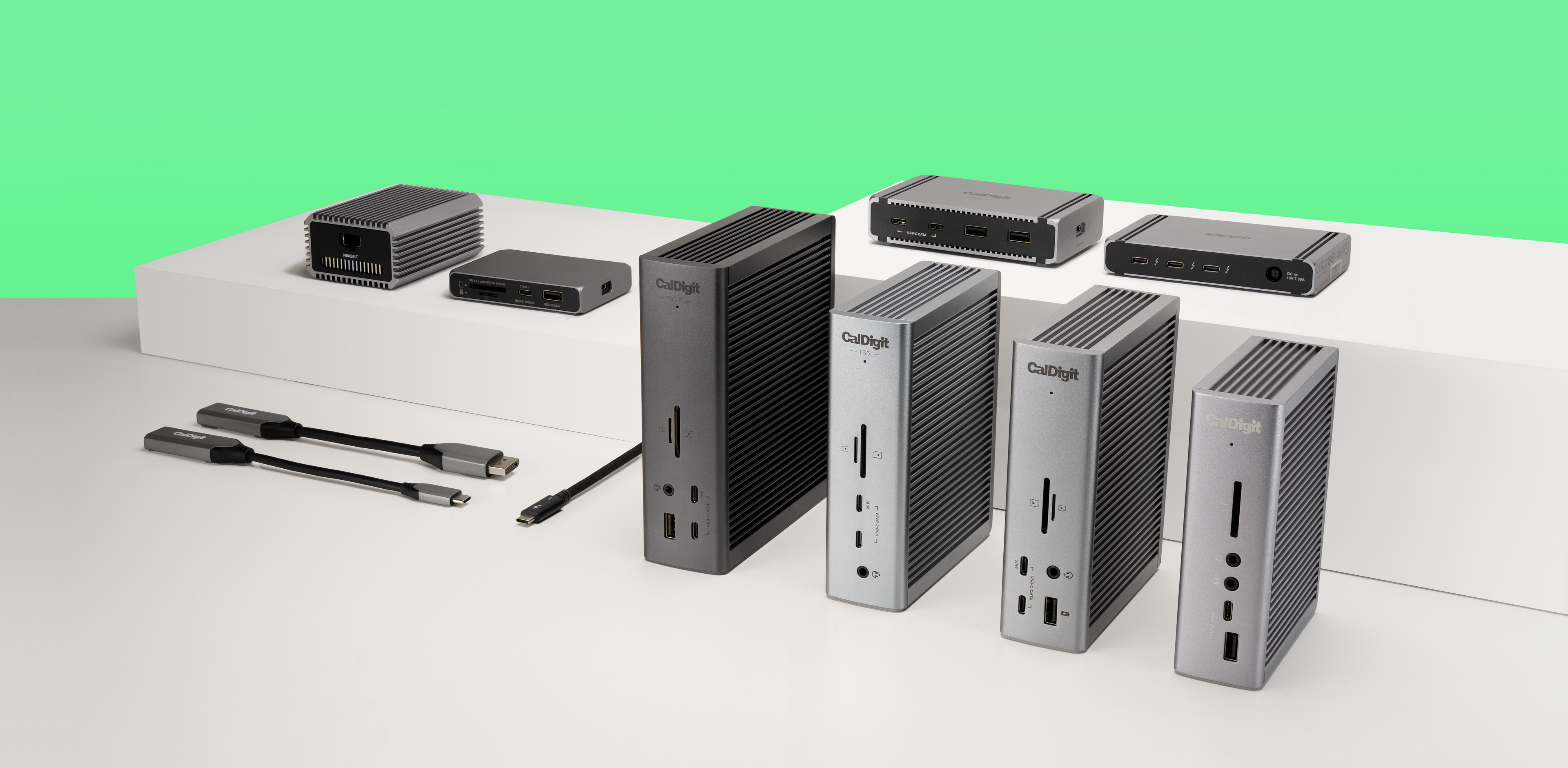 A white table with a green wall. On the table is CalDigit's product range.