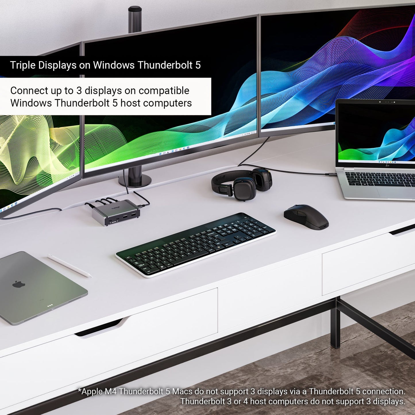 The Element 5 Hub on a desk connected to a Windows computer and three monitors. Text on the image says "Triple Displays on Windows Thunderbolt 5", and "Connect up to 3 displays on compatible Windows Thunderbolt 5 host computers".