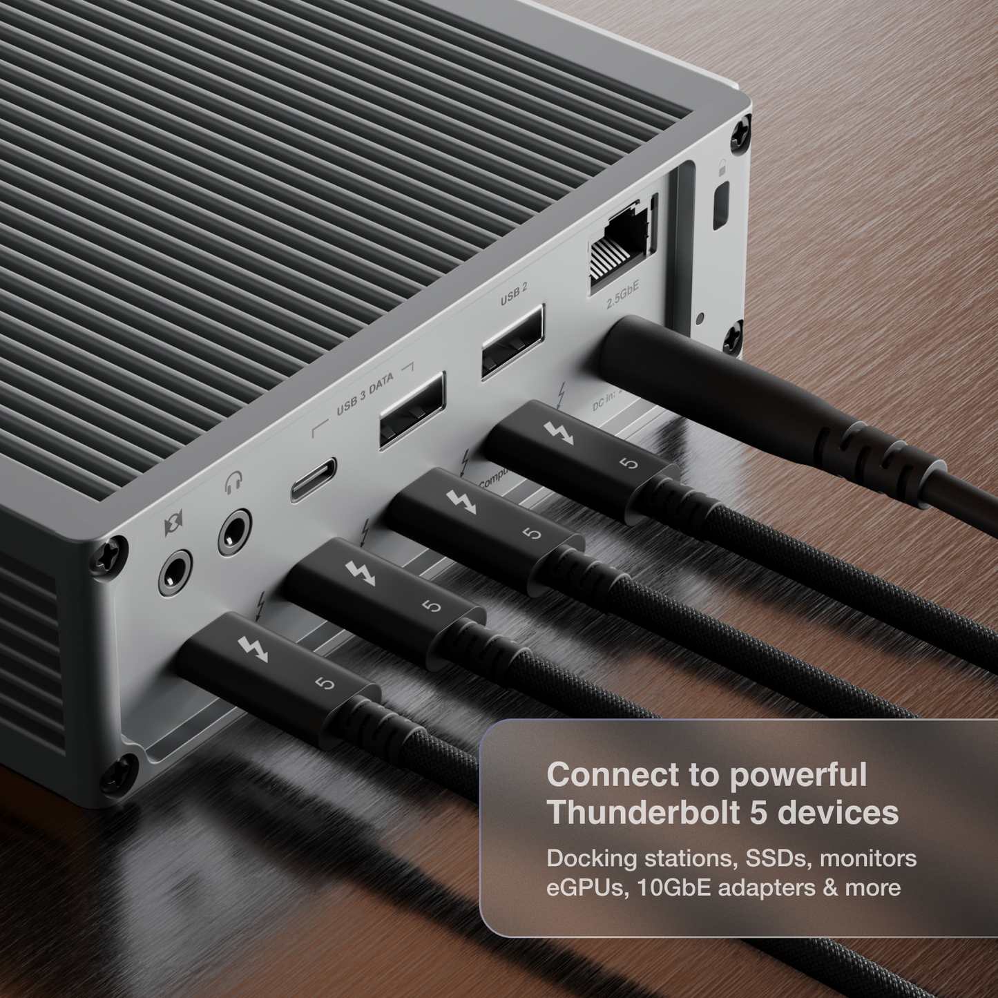 An image of a dock on a desk and four Thunderbolt 5 Pro Cables connected to its Thunderbolt ports.