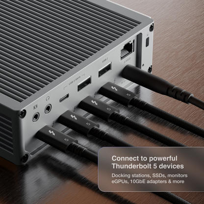 An image of a dock on a desk and four Thunderbolt 5 Pro Cables connected to its Thunderbolt ports.