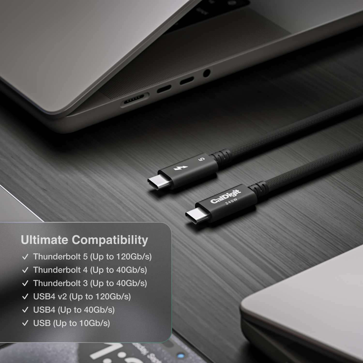 An image of a desk showing two Thunderbolt 5 Pro cables on a desk. Around the cables are various devices. Text on the image talks about the cable's compatibility.